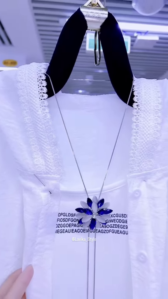 Elegant White Layered Outfit with Striking Blue Necklace - Photo 4